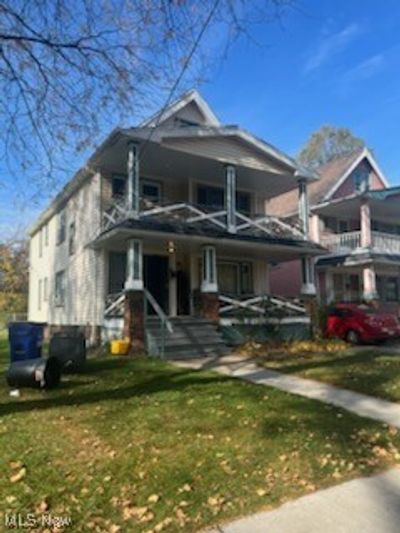 View of front of property featuring a front lawn, a balcony, and covered porch | Image 2