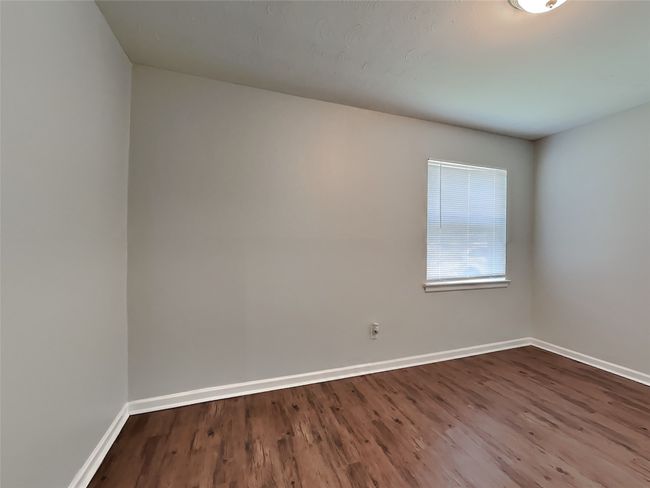 Empty room featuring dark wood-type flooring and baseboards | Image 11