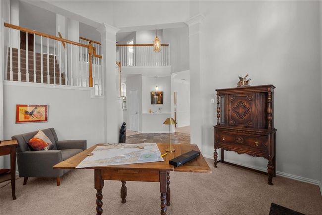 This flex space offers a bright and inviting area with high ceilings and large windows for ample natural light, making it ideal for a home office or study. | Image 16
