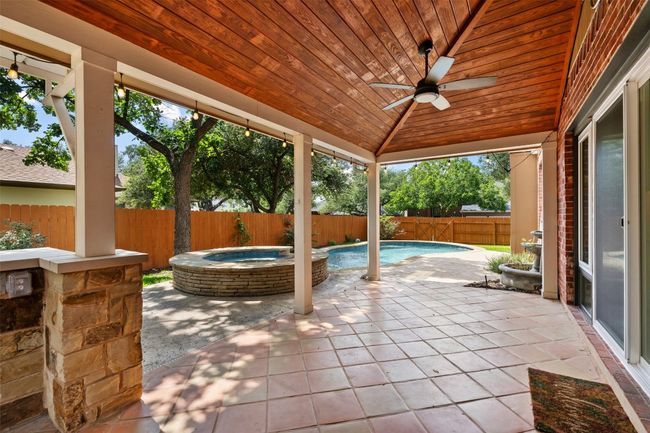 Covered patio overlooking the hot tub and pool. | Image 32