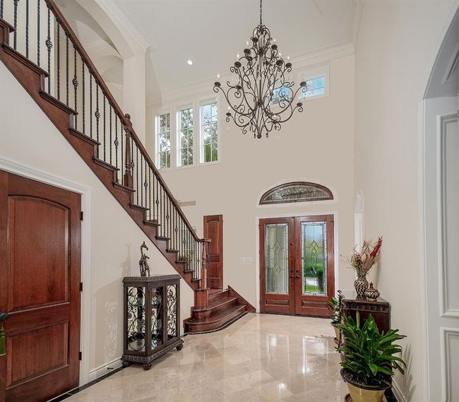 Impressive foyer showcases soaring ceilings, neutral paint and gorgeous trim work | Image 5