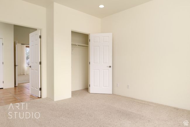 Unfurnished bedroom featuring recessed lighting, carpet flooring, tile patterned floors, and a closet | Image 33