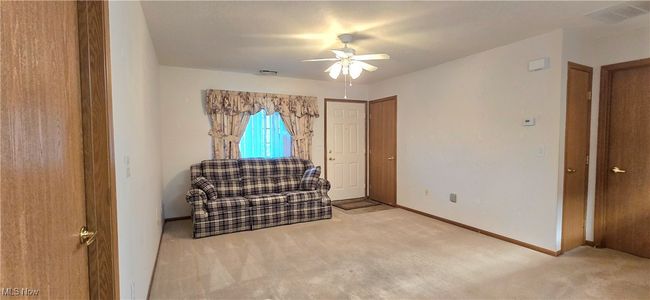 Sitting room featuring carpet flooring, ceiling fan, and baseboards | Image 13
