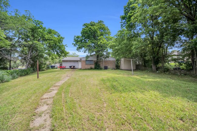 View of yard with a shed, an outbuilding, and fence | Image 29