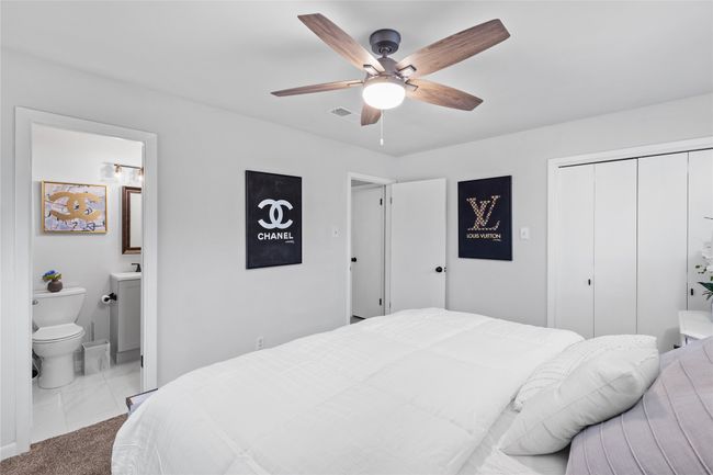 Bedroom with visible vents, ensuite bath, ceiling fan, carpet floors, and a closet | Image 27