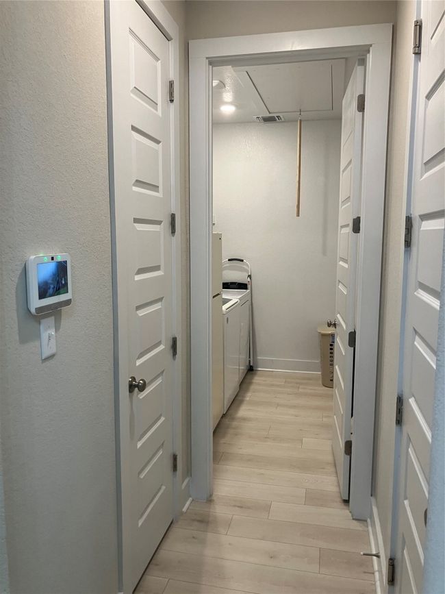 Washroom featuring light wood-style floors, baseboards, and attic access | Image 23