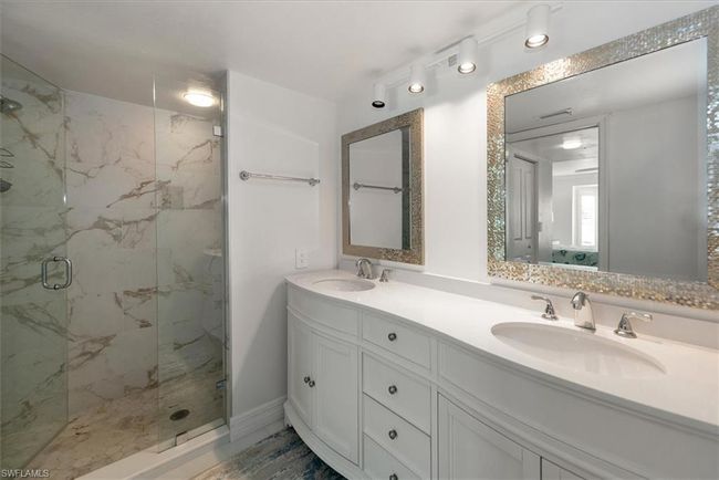 Full bath featuring a marble finish shower and double vanity | Image 19
