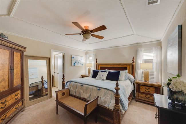 Bedroom with light colored carpet, crown molding, and ceiling fan | Image 20