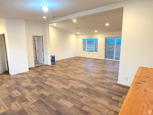 looking from fireplace to entry on left and dining area in the back right. | Image 11