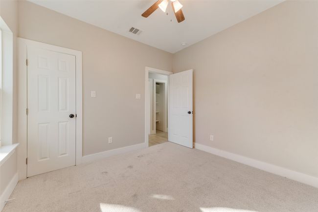 Unfurnished bedroom featuring light colored carpet and a ceiling fan | Image 18