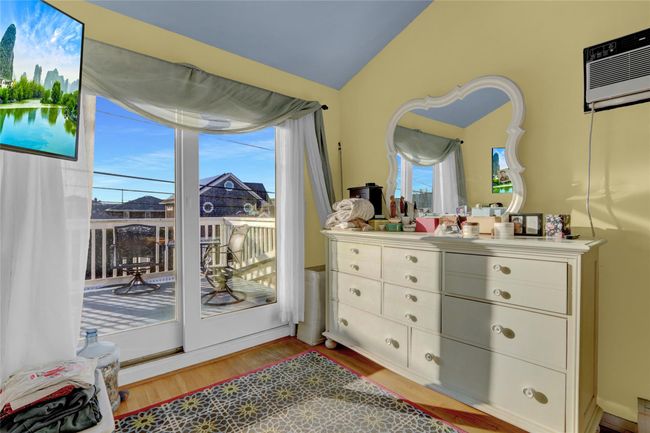 Doorway to outside with hardwood / wood-style floors, vaulted ceiling, and a wall mounted air conditioner | Image 26