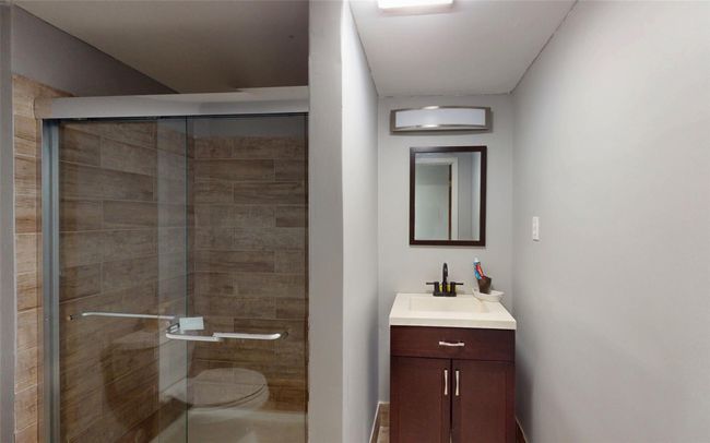 Full bathroom with vanity, toilet, and a shower stall | Image 39