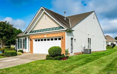 View of front of home with central AC and a front yard | Image 2