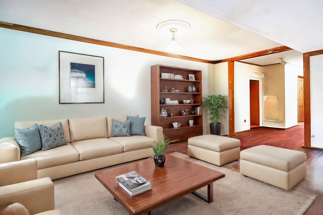 Living area with wood finished floors and ornamental molding | Image 10