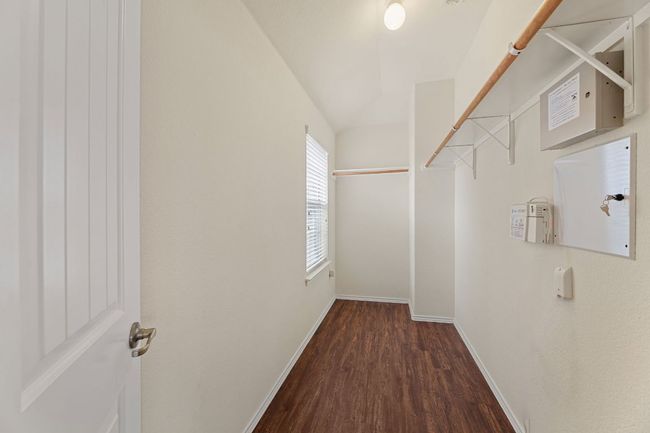 Spacious closet with wood finished floors and lofted ceiling | Image 23