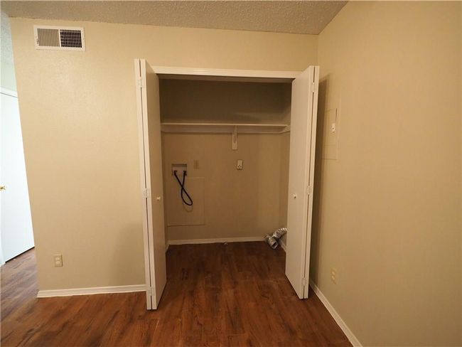 Laundry room featuring washer hookup, wood finished floors, and baseboards | Image 9