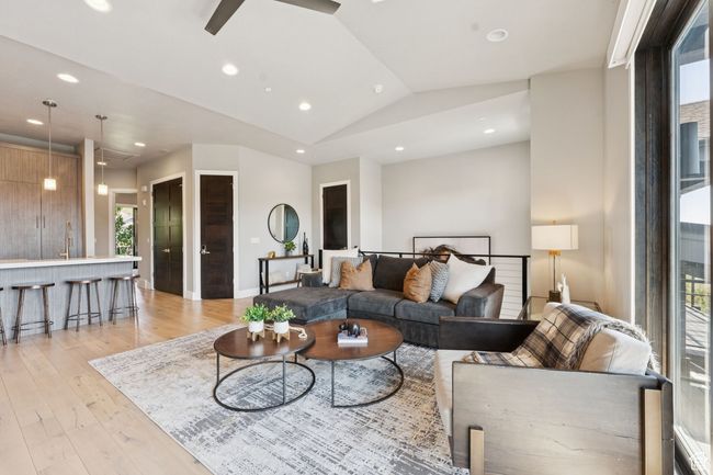 Living area featuring light wood-style flooring, ceiling fan, recessed lighting, and vaulted ceiling | Image 13