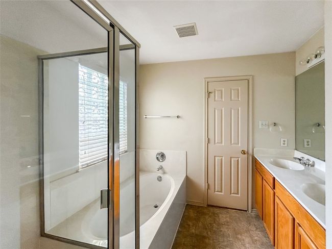 Primary Bathroom with a Dual Vanity Sink and a Framed Glass Shower wit a Separate Tub | Image 16