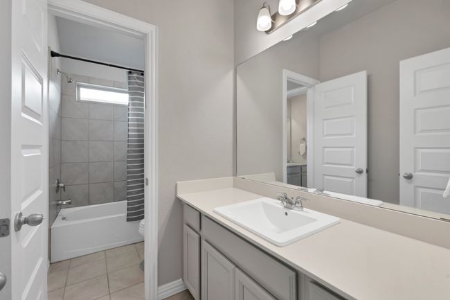 Jack and Jill Bathroom with tile patterned floors, shower / tub combo, toilet, and vanity | Image 29