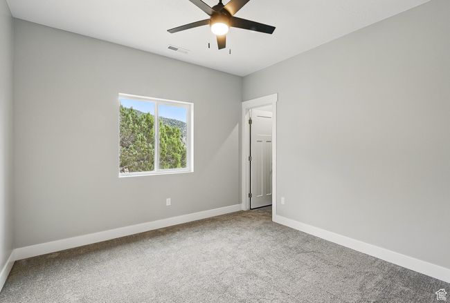 Carpeted spare room with baseboards and a ceiling fan | Image 36
