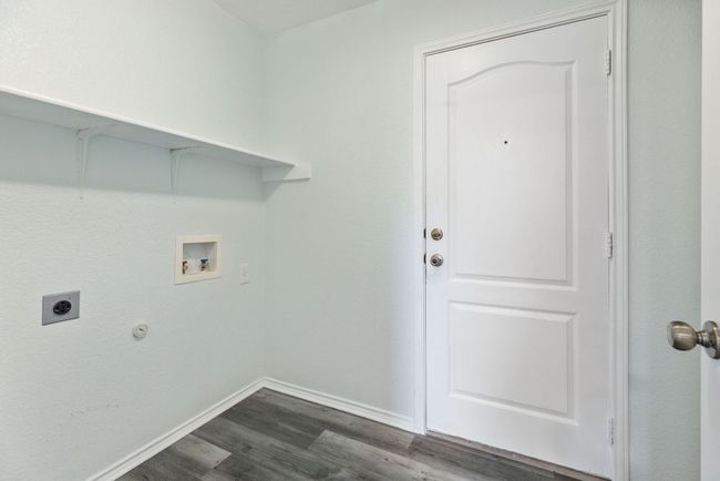 Laundry area featuring hookup for an electric dryer, Grey wood-style vinyl floors, washer hookup, and baseboards | Image 19