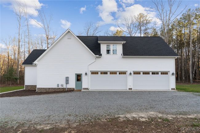 View of side of home with driveway and roof with shingles | Image 48
