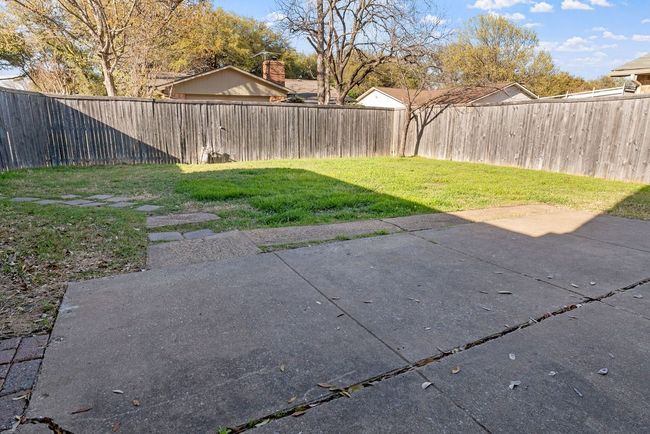 View of yard with a fenced backyard and a patio area | Image 37