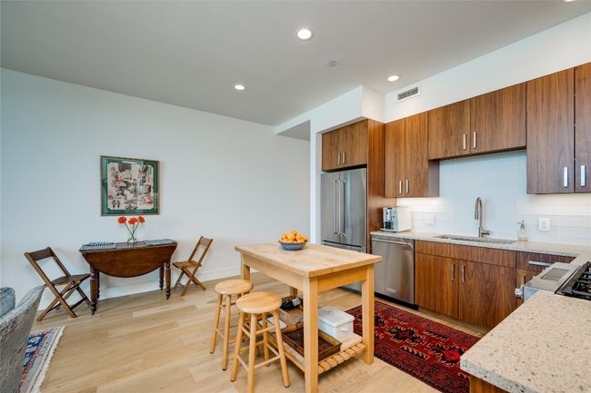 Kitchen with appliances with stainless steel finishes, light wood-style flooring, decorative backsplash, brown cabinetry, and recessed lighting | Image 6