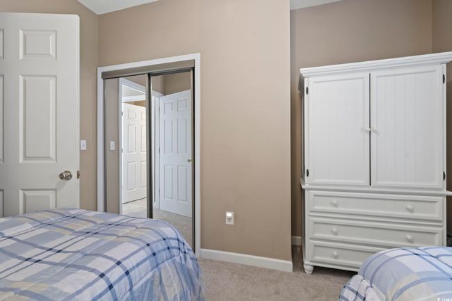Bedroom featuring light colored carpet, baseboards, and a closet | Image 26