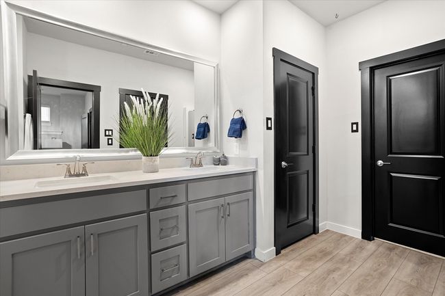 Full bath featuring double vanity and light wood-style floors | Image 16
