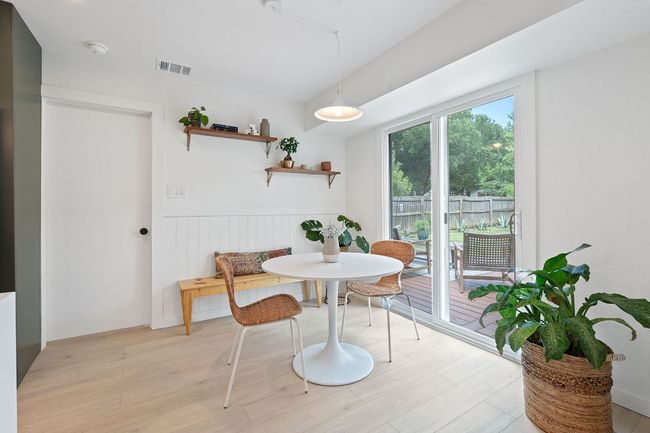 Dining area with a wainscoted wall and light wood-style floors | Image 7