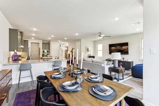 Dining area with wood finished floors, ceiling fan, recessed lighting, and stairs | Image 39