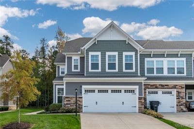 View of front of house featuring a front lawn and a garage | Image 1