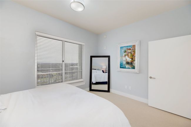 Bedroom featuring light carpet and baseboards | Image 15