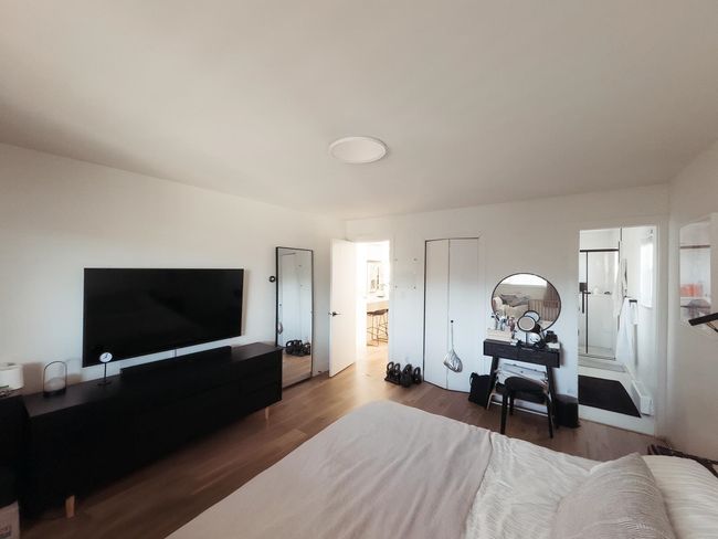 Bedroom with wood finished floors and a closet | Image 19