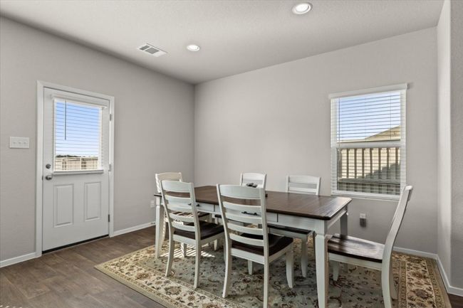 Dining area with wood finished floors, baseboards, and recessed lighting | Image 15