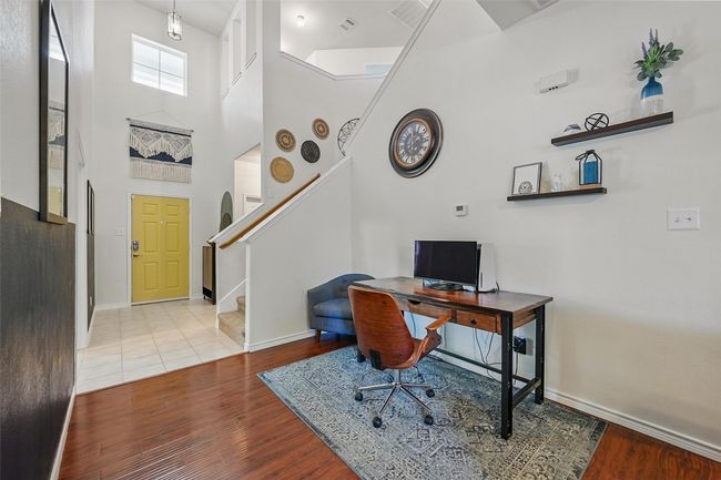 Office area with wood finished floors, baseboards, and a high ceiling | Image 4