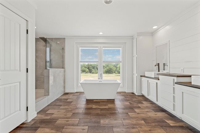 Bathroom with vanity, a shower stall, a soaking tub, dark wood-style floors, and recessed lighting | Image 15