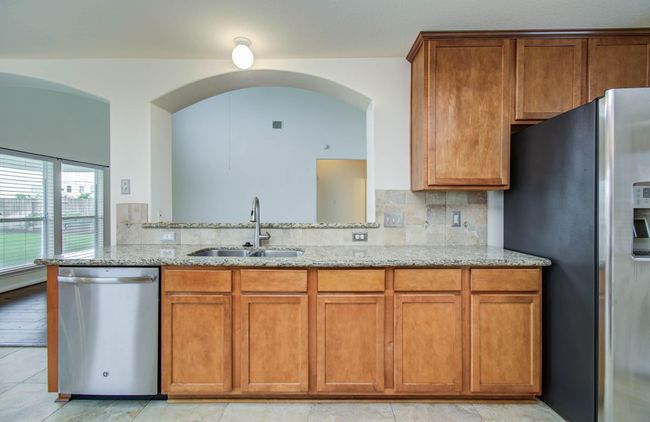 Kitchen is open to family room and adjacent breakfast room. | Image 11