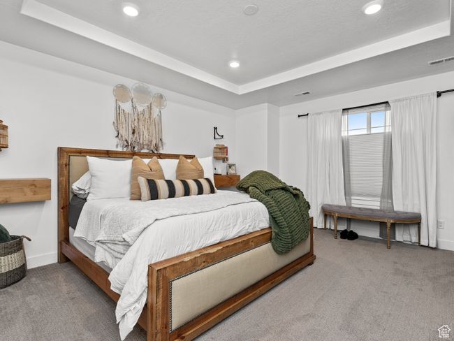 Bedroom featuring carpet flooring, a tray ceiling, and recessed lighting | Image 37
