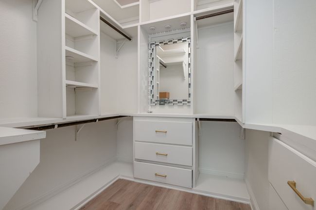 Spacious closet featuring wood finished floors | Image 16