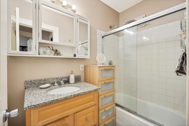 The updated full bathroom includes ample storage space. | Image 20