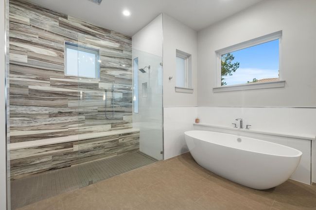 Primary Bathroom with tile walls, a soaking tub, recessed lighting, walk in shower, and tile patterned floors | Image 17