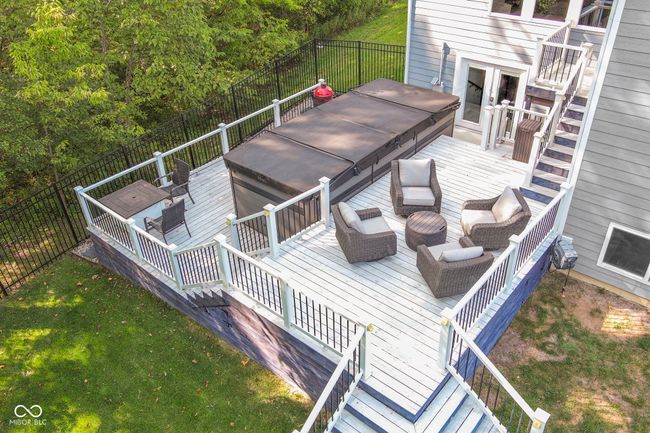Multi-level deck leads to a fully fence backyard. The fence is wrought iron style and is a full 6 ft. tall! | Image 64