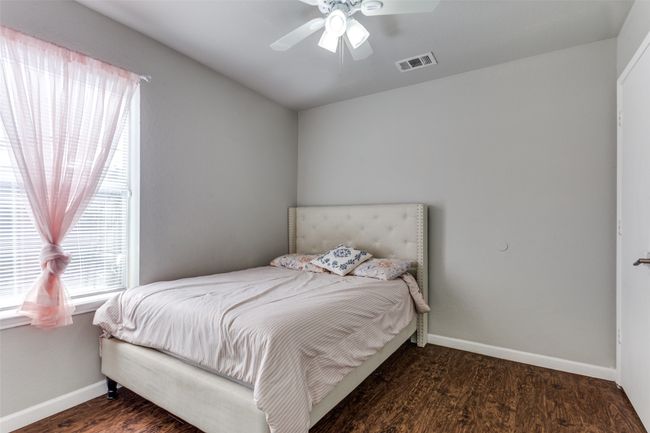 Bedroom featuring ceiling fan and dark hardwood / wood-style flooring | Image 12