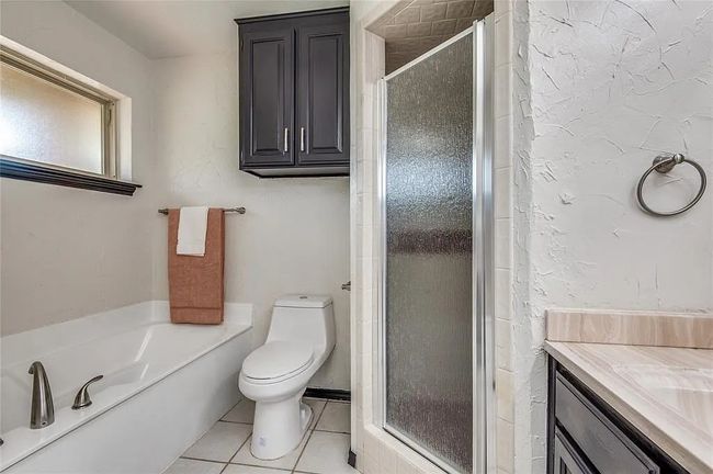 Bathroom with vanity, a shower stall, toilet, and tile patterned floors | Image 7