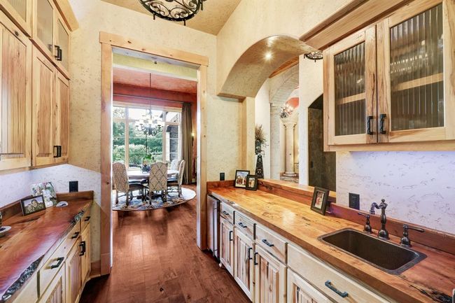 The wet bar seamlessly blends the formal dining room and the kitchen. | Image 9