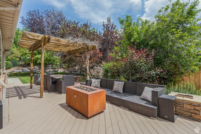Wooden terrace with an outdoor living space with a fire pit and a pergola | Image 76