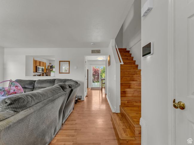 Living area with light wood-type flooring and stairway | Image 6