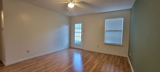 Unfurnished room featuring light wood-type flooring, a ceiling fan, baseboards, and a textured ceiling | Image 10